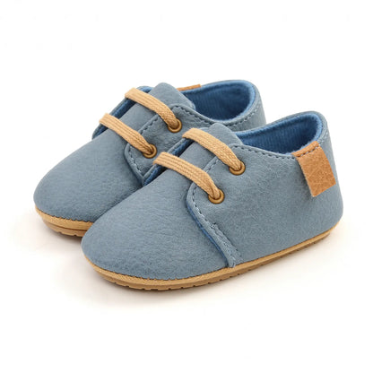 Pair of unisex tan toddler moccasins, soft sole for comfortable movement
