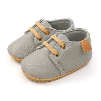 Close-up of navy blue leather infant moccasins, lightweight and breathable