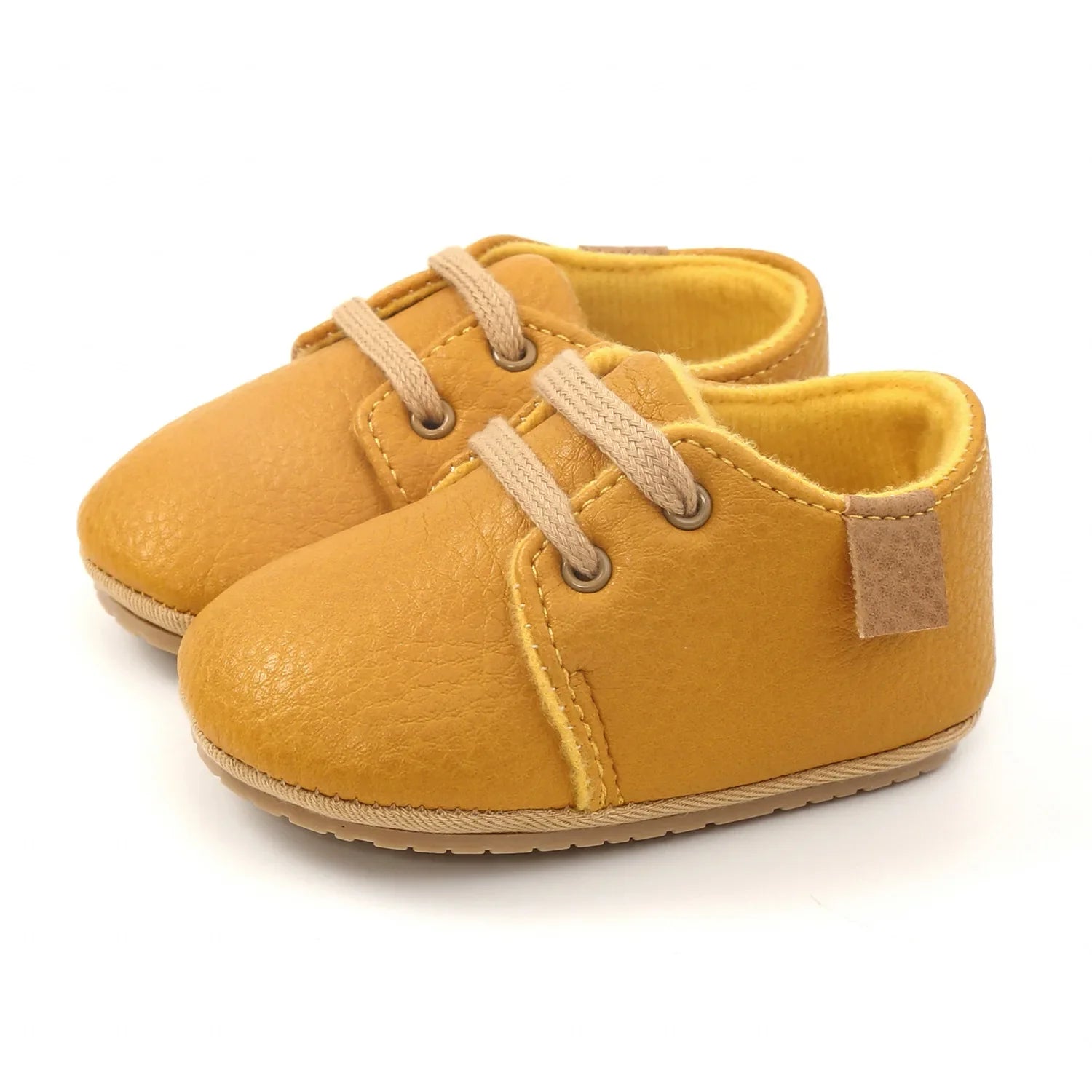 Close-up of pink leather infant moccasins, breathable and comfortable toddler shoes