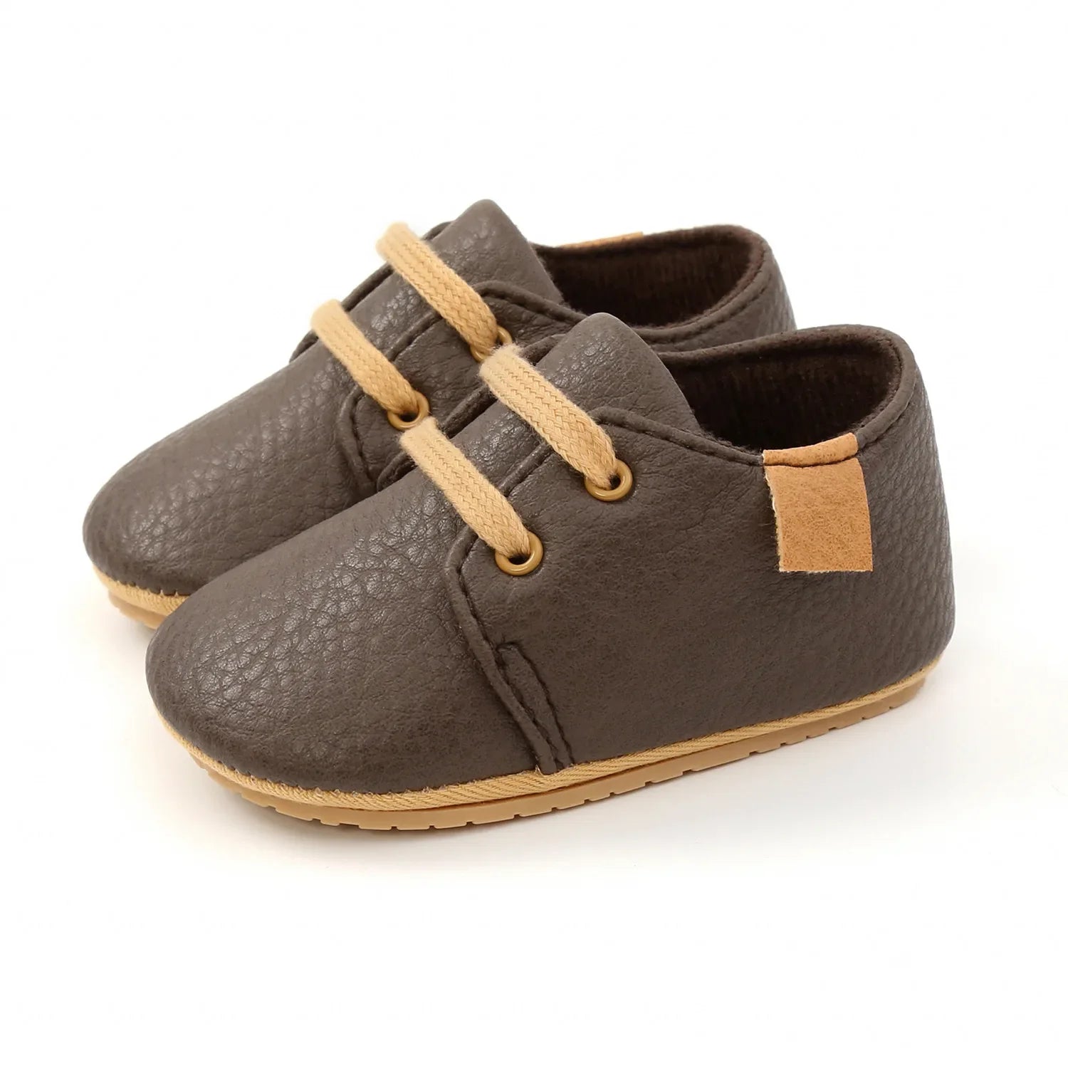 Close-up of grey leather infant moccasins, lightweight and breathable toddler shoes