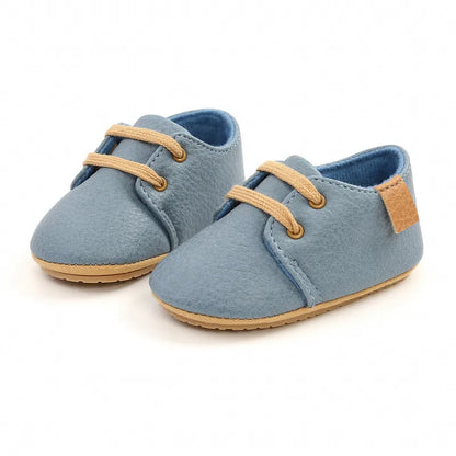 Side view of retro lace-up baby shoes in genuine brown leather with soft sole