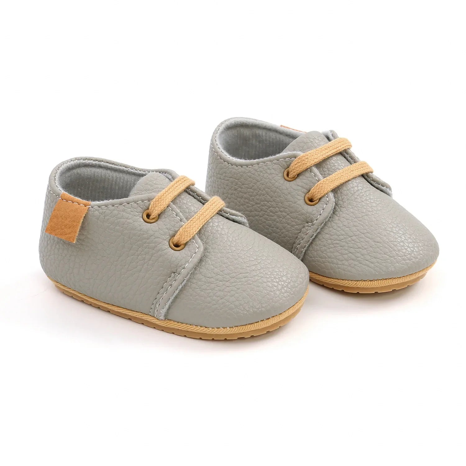 Close-up of soft black leather infant moccasins, ideal first walking shoes
