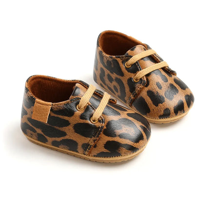Top-down view of anti-slip retro black baby shoes, perfect for new walkers