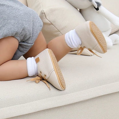 Baby wearing brown leather moccasins, showcasing soft sole and comfortable fit