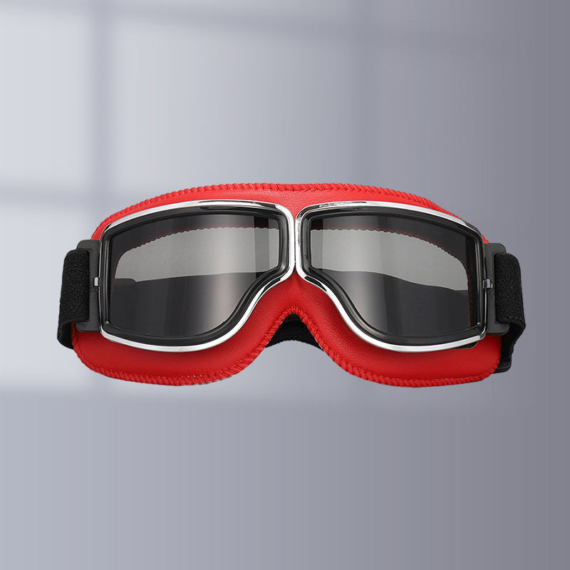 Vintage style riding goggles, black frame & tinted lenses for sun protection on motorcycles.