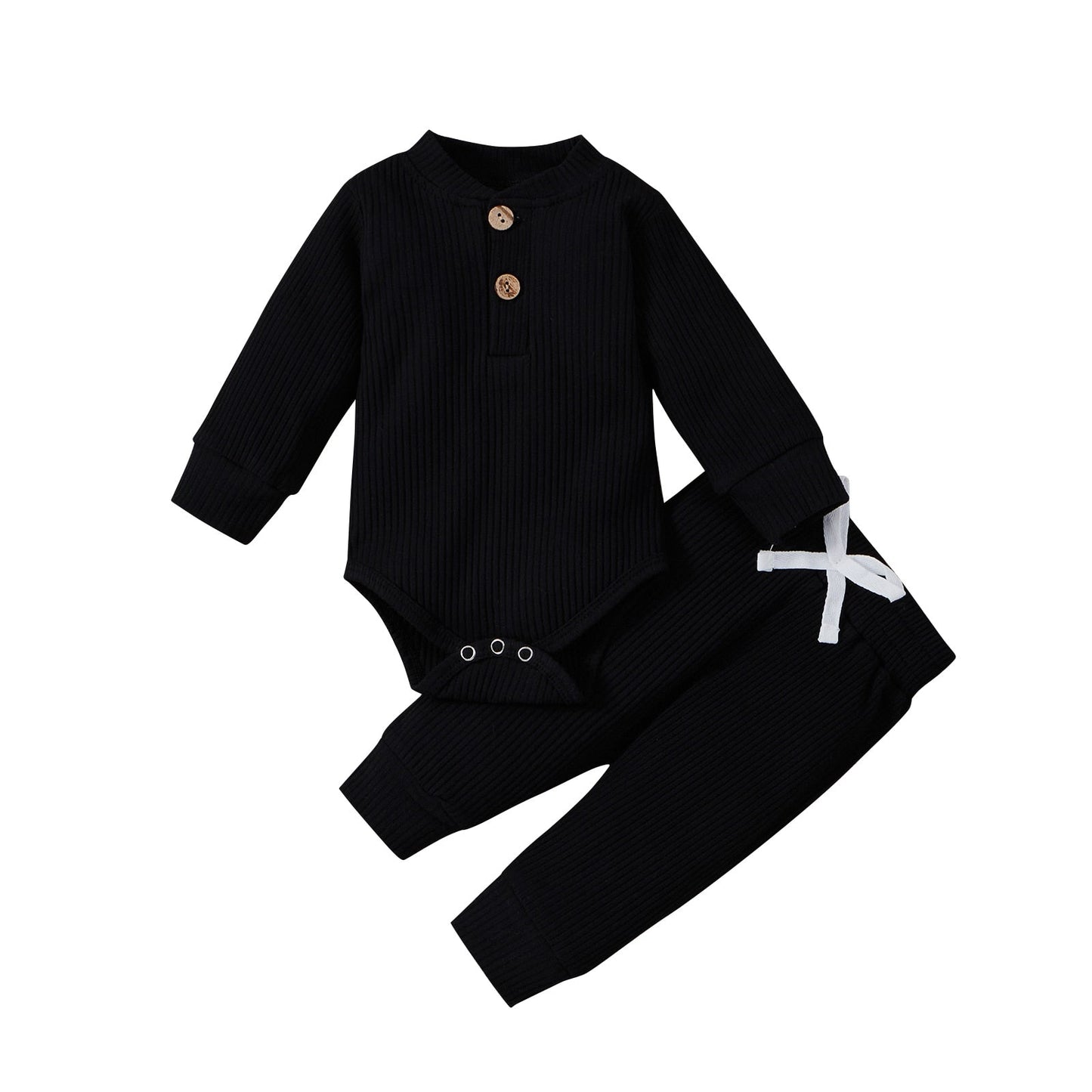 Detail of snaps on the bottom of a ribbed cotton long sleeve romper for easy changes