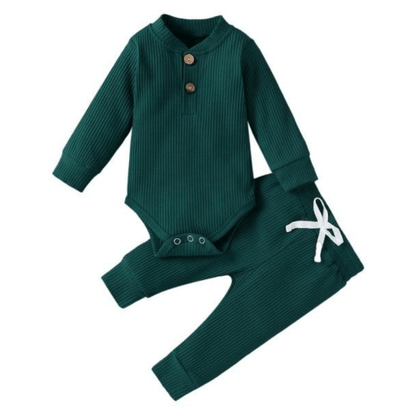 Close-up of ribbed cotton fabric on a long sleeve baby romper and pants set