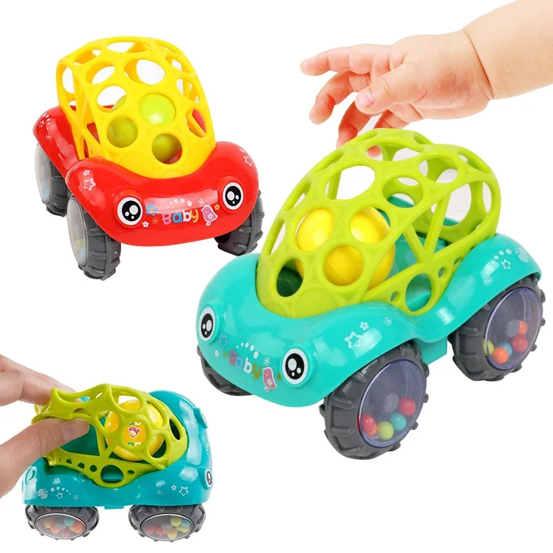 Three colorful rattle toy cars (red, yellow, blue) lined up, promoting sensory development in toddlers.