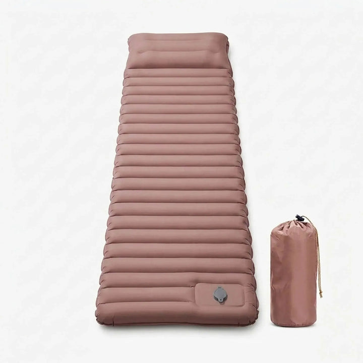 Lightweight self-inflating sleeping pad rolled up with straps, ready for portable outdoor adventures & hiking.