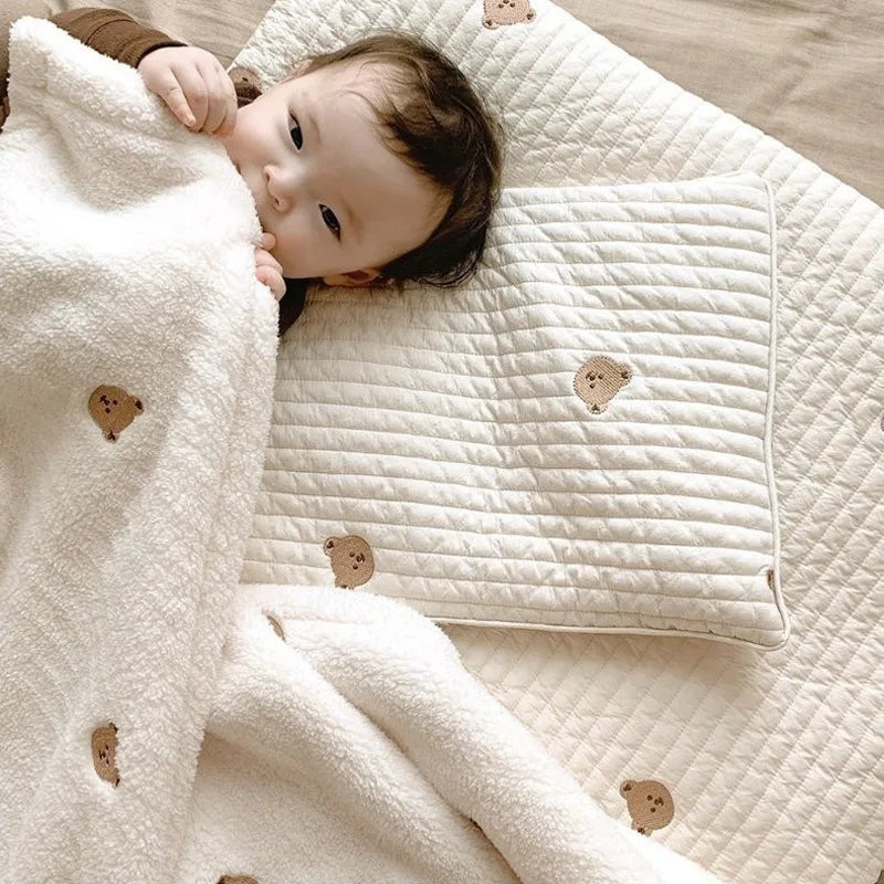 Soft gray fleece baby blanket, ideal for swaddling infants & keeping toddlers warm all seasons.