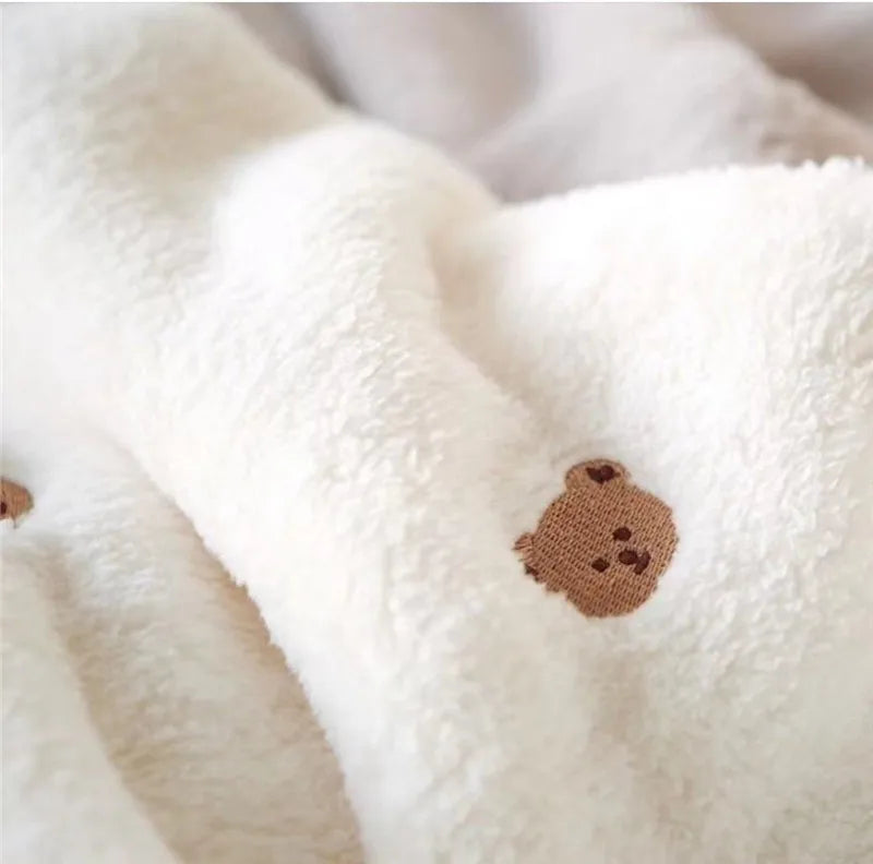 Newborn soft fleece swaddle blanket in cream, offering supreme comfort for delicate skin.