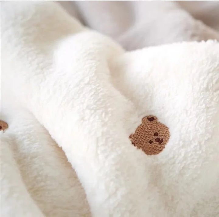Newborn soft fleece swaddle blanket in cream, offering supreme comfort for delicate skin.
