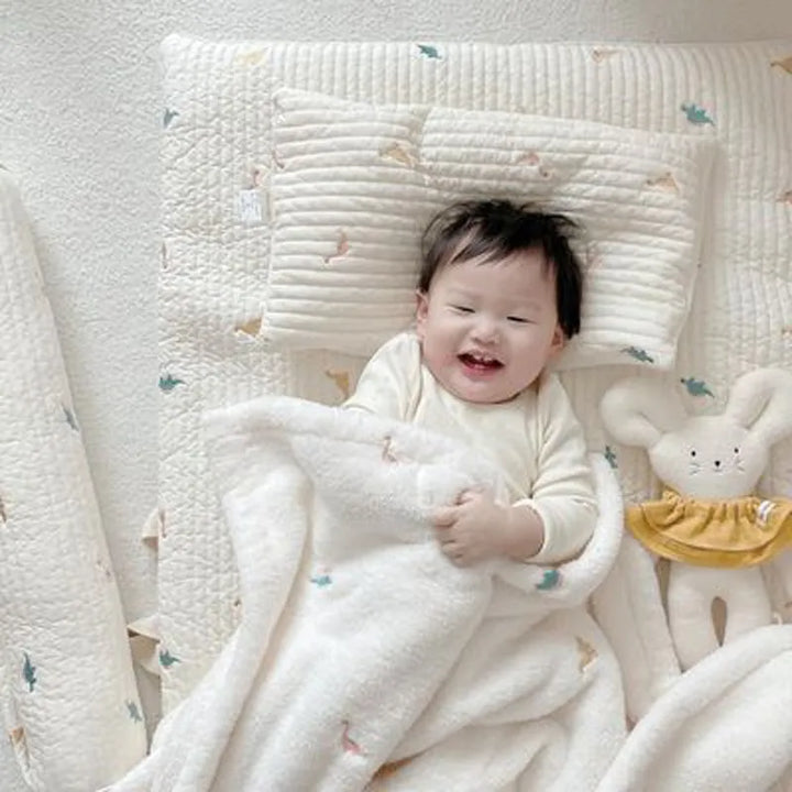 Adorable unisex fleece blanket with playful animal pattern, a great nursery decor addition.