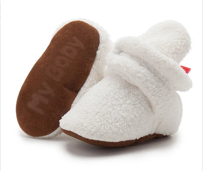 Unisex baby booties, soft fluff, anti-slip, perfect newborn shoes for early development.