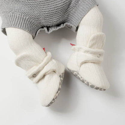 Soft fluff baby booties in a gift box, unisex design, cozy first walkers for infants, cotton.