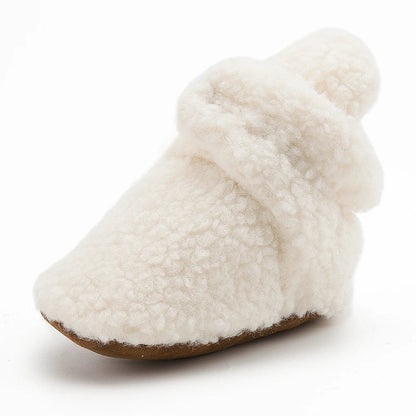 Unisex white baby booties, soft fluff, anti-slip soles, warm cotton for infants' first steps.