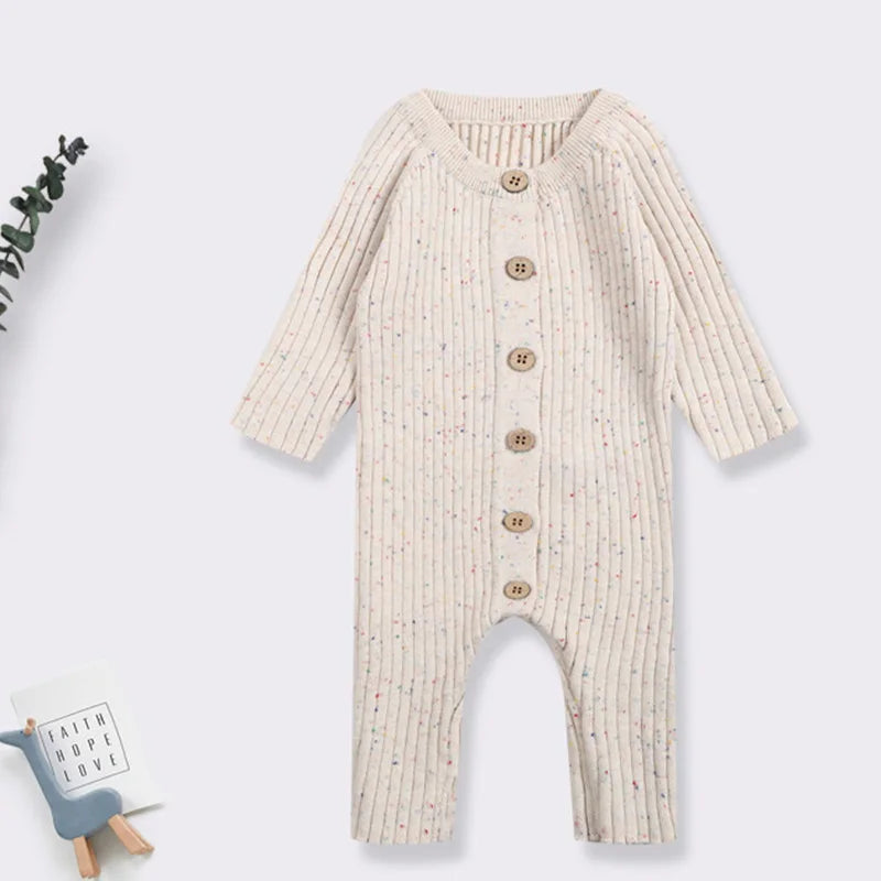Stylish knitted cotton baby romper, a versatile piece of infant apparel in a neutral shade
