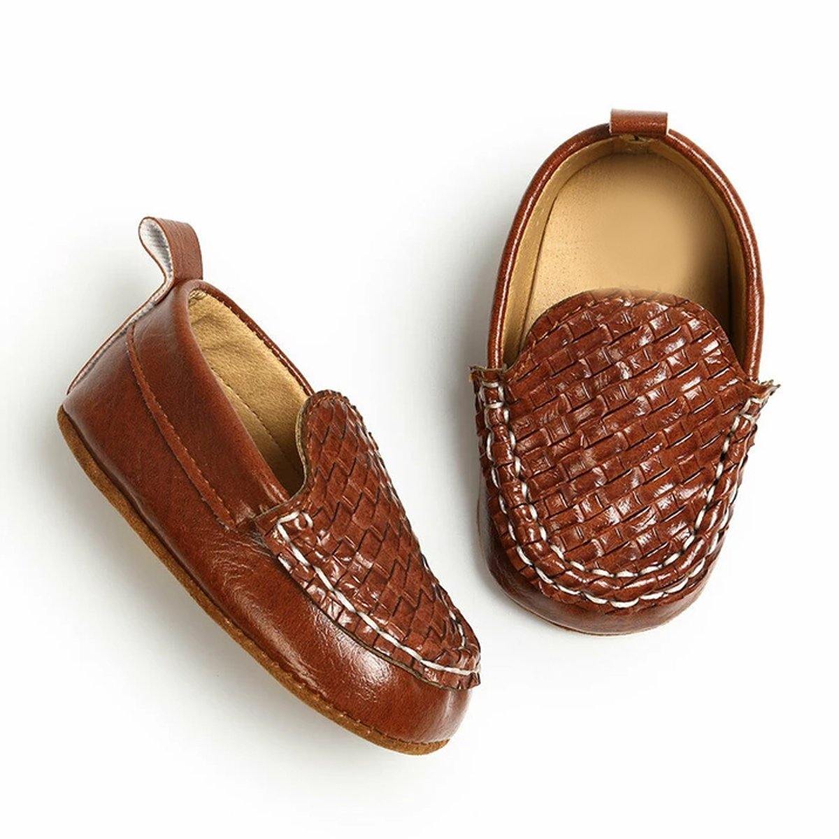 Pair of unisex soft sole leather baby moccasin boots, essential first walking shoes for growing feet