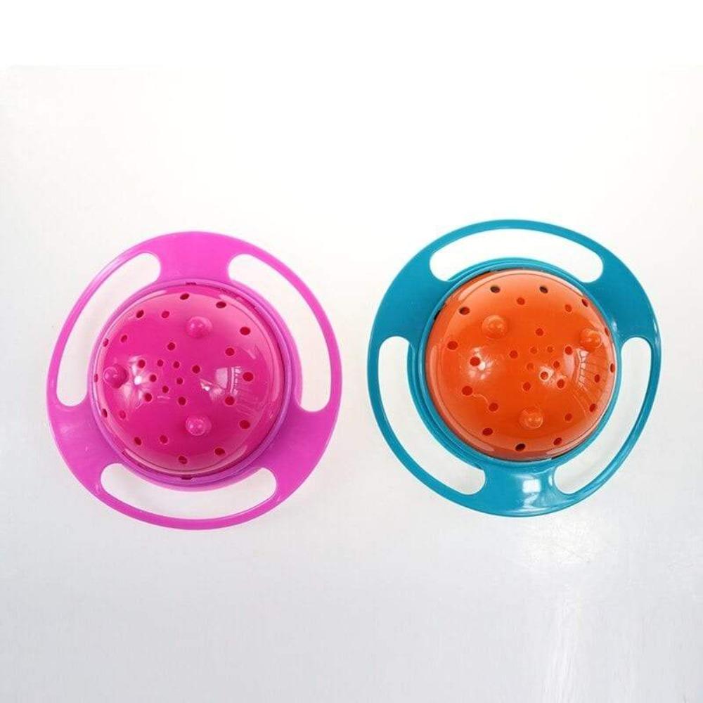 Toddler using a red spill-proof 360 rotating gyro bowl with snack, mess-free