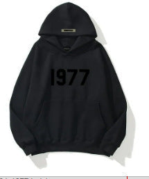 Comfortable unisex raglan sleeve hoodie featuring a bold 1977 print for relaxed streetwear.
