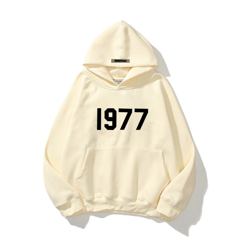 Unisex raglan sleeve streetwear hoodie featuring a prominent 1977 print and kangaroo pocket.