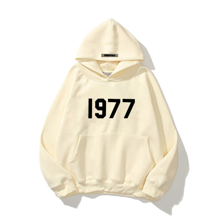 Unisex raglan sleeve streetwear hoodie featuring a prominent 1977 print and kangaroo pocket.