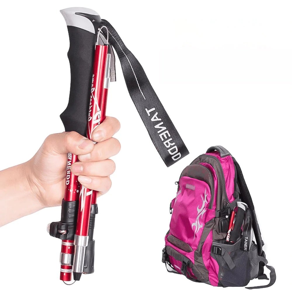 Red adjustable telescopic hiking stick, ideal for stability on rugged trails. Essential trekking & camping gear.
