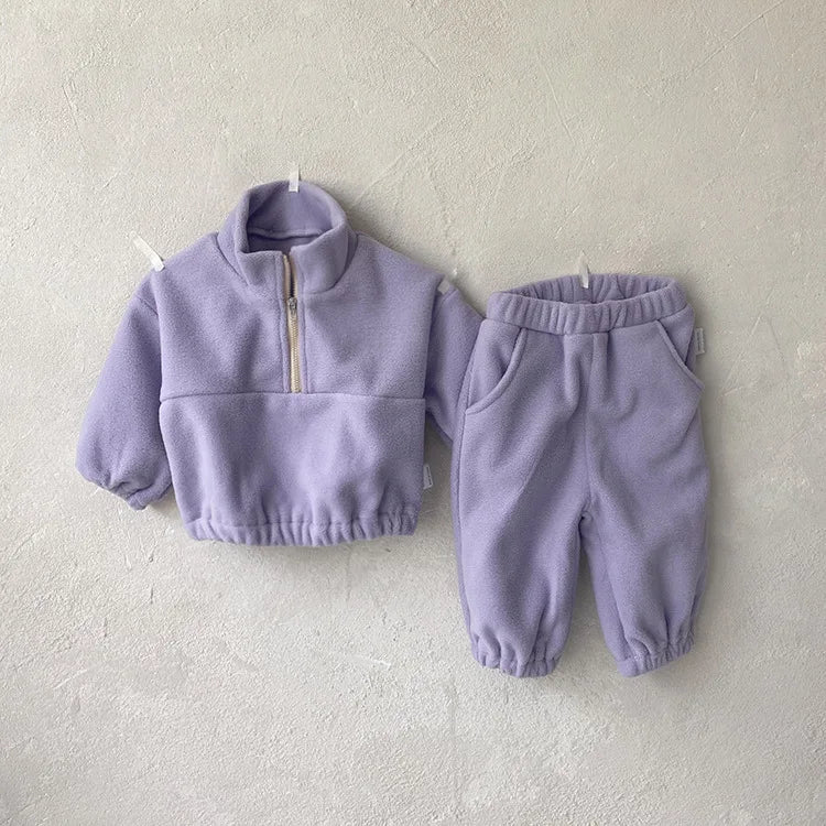 Baby wearing a gray fleece hoodie and joggers ensemble, cozy and warm