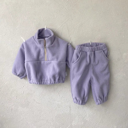 Baby wearing a gray fleece hoodie and joggers ensemble, cozy and warm