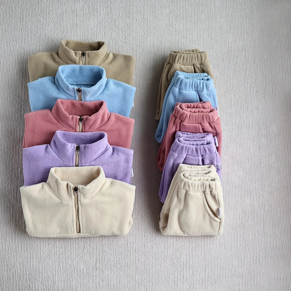 Toddler modeling a cozy gray fleece hoodie and matching pants, autumn essential