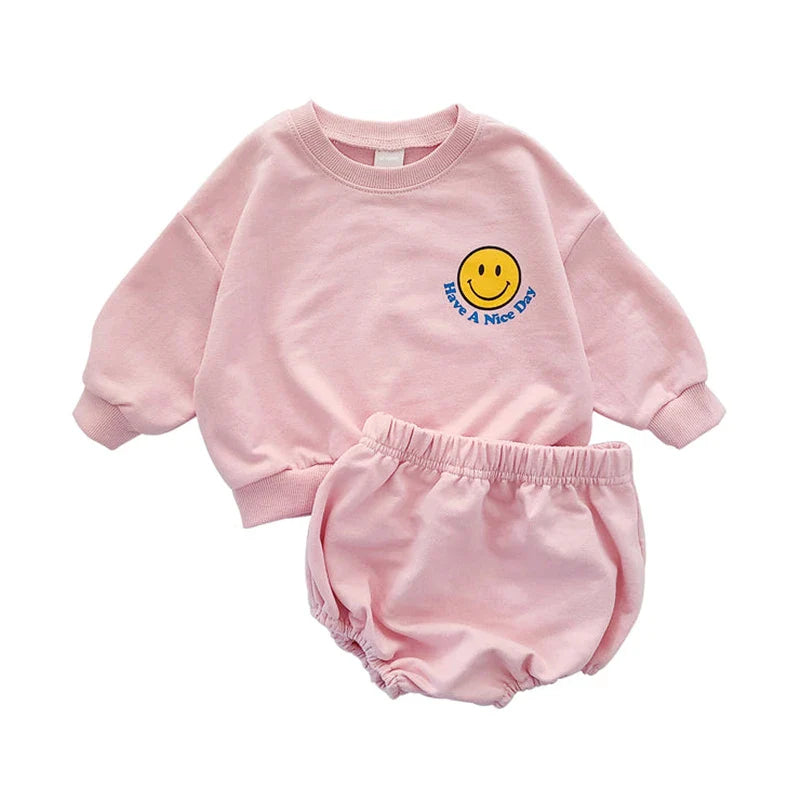 Comfortable unisex toddler outfit: grey sweatshirt with smiley face, black shorts in cotton