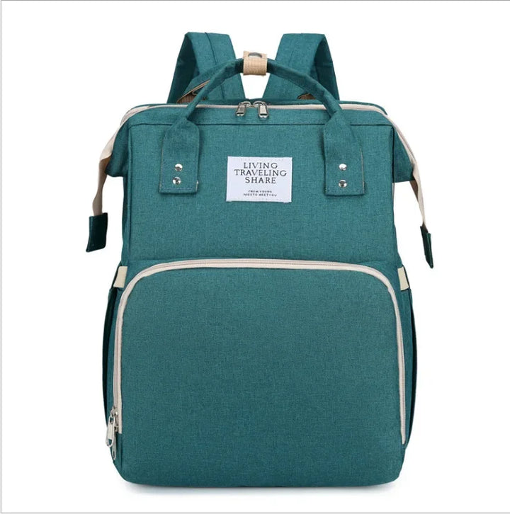 On-the-go baby changing station & portable crib in a stylish travel diaper bag.