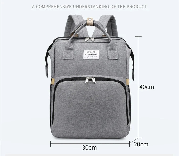 Easy-to-clean unisex travel diaper bag with a foldable crib and diaper changing pad.