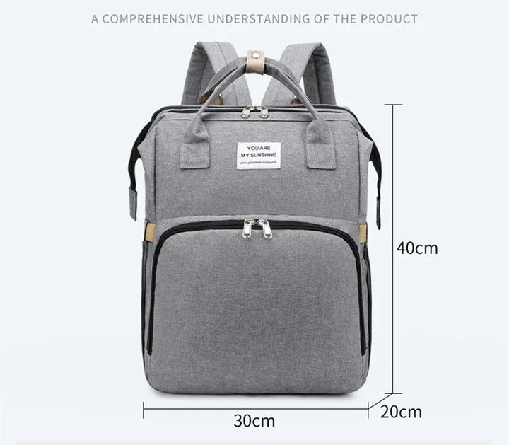 Easy-to-clean unisex travel diaper bag with a foldable crib and diaper changing pad.