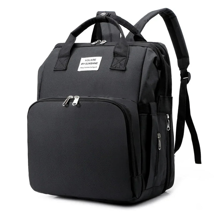 Practical parenting essential: travel diaper bag with a pop-up baby crib.