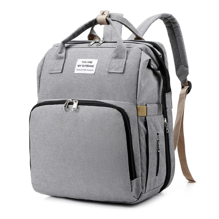 Large capacity unisex diaper backpack with a foldable baby crib & changing pad.