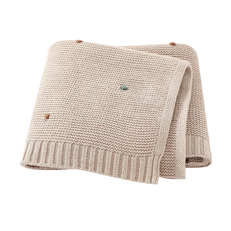 Unisex ultra-soft knitted baby blanket in white, essential for newborn comfort & nursery decor