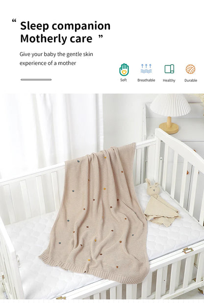 Close-up of the breathable knit fabric of the ultra-soft baby blanket, perfect for all weather