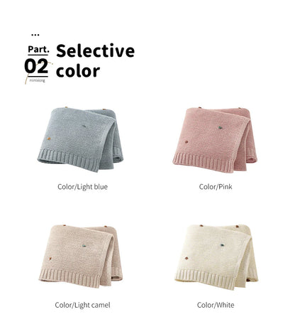 Unisex ultra-soft blanket folded beside baby toys, enhancing nursery decor and providing warmth