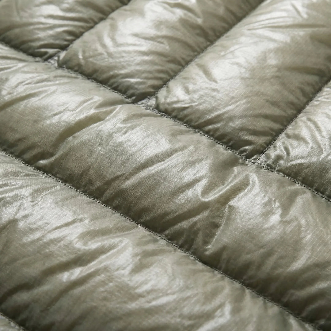 Compact ultralight down mummy sleeping bag, ideal for travel. Unisex design ensures warmth for backpackers.