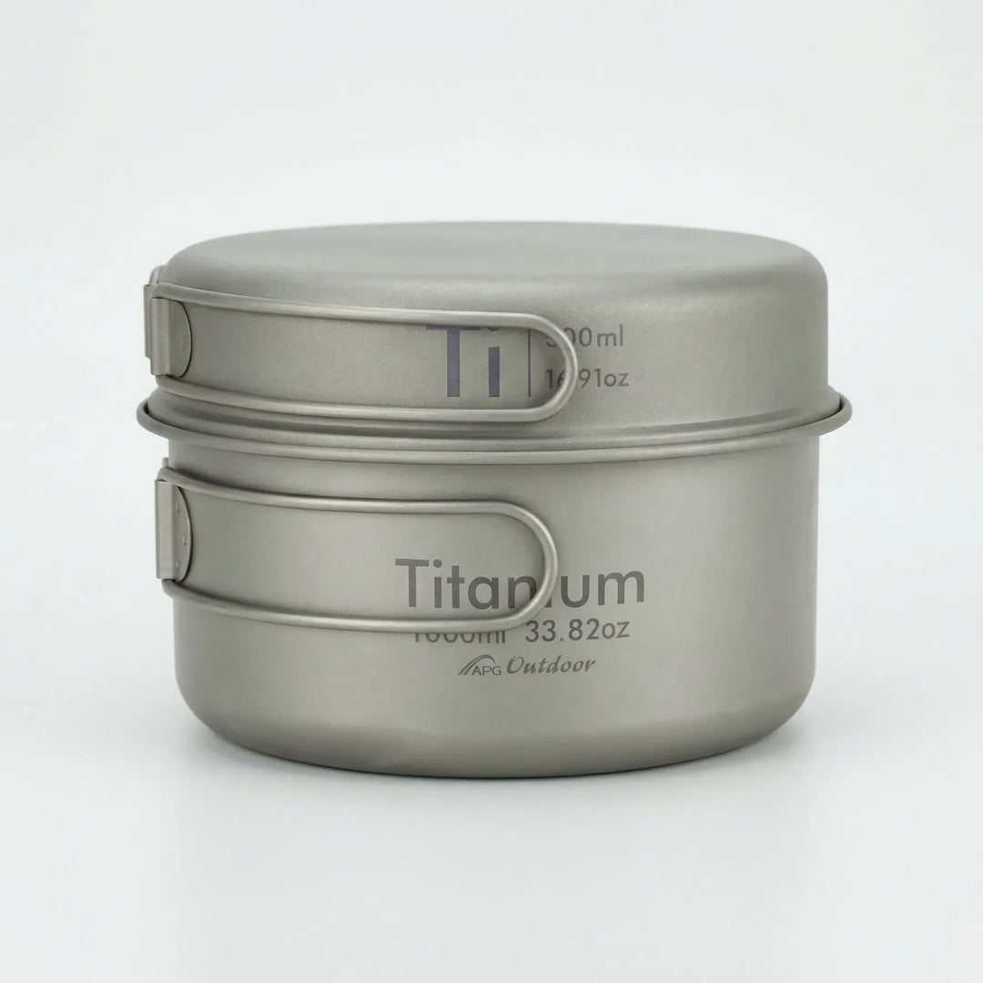 Compact titanium folding mess kit for camping, hiking, and backpacking; essential outdoor cookware.