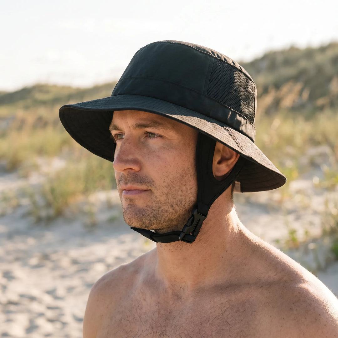Unisex ventilated surf bucket hat for outdoor adventures, offering sun protection with a wide brim and chin strap.