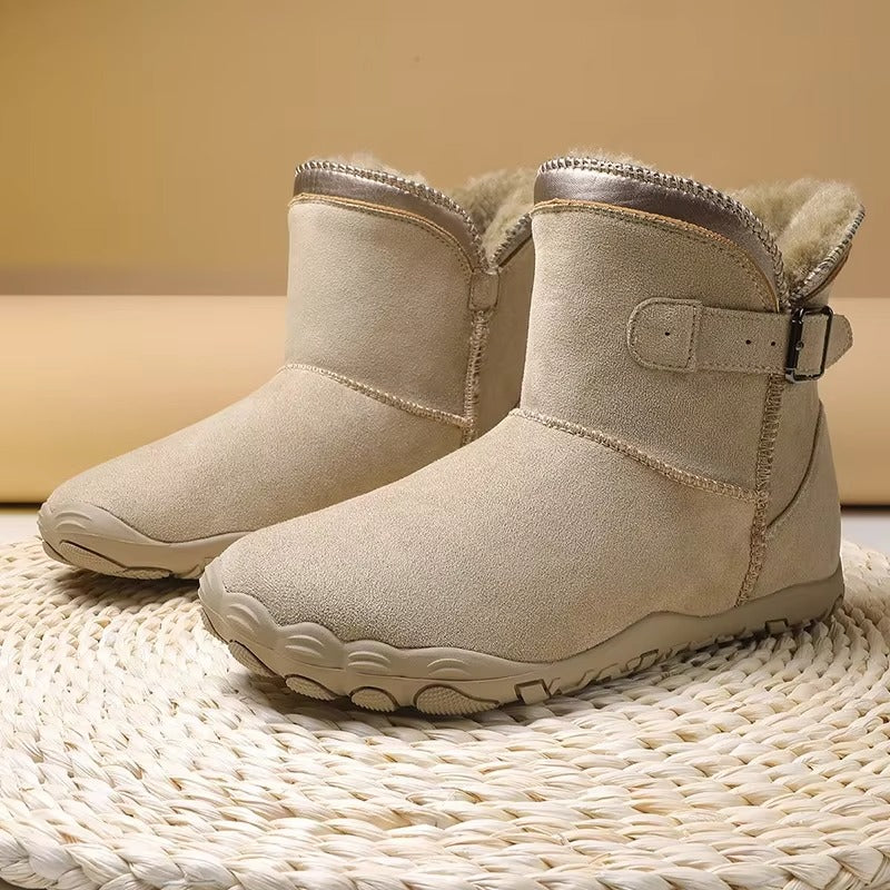 Person walking in unisex warm winter barefoot boots, showcasing natural movement.