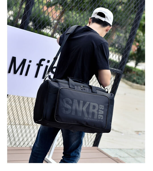 Side view of the water-resistant travel bag, highlighting its durable construction & carry handles.