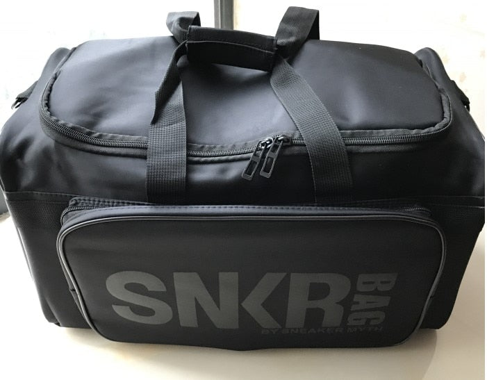 Unisex water-resistant travel bag packed with two pairs of sneakers and gym clothes.