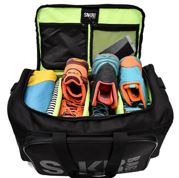 Black water-resistant duffel bag, featuring dedicated shoe compartments & secure zipper closure.