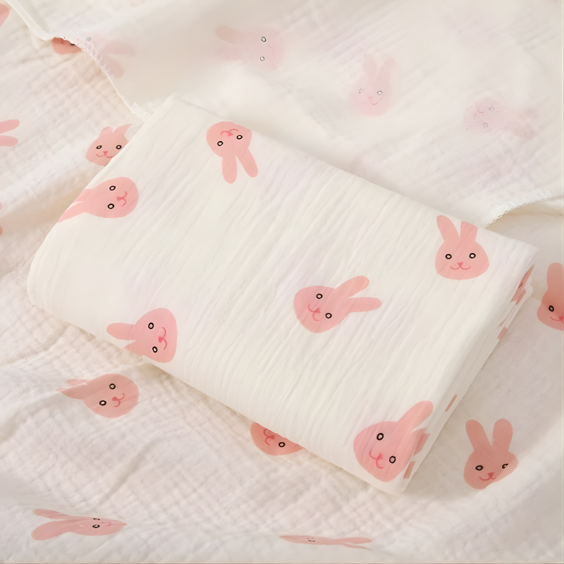 Close-up of a white cotton surfaced waterproof baby sleep mat for nursery use.