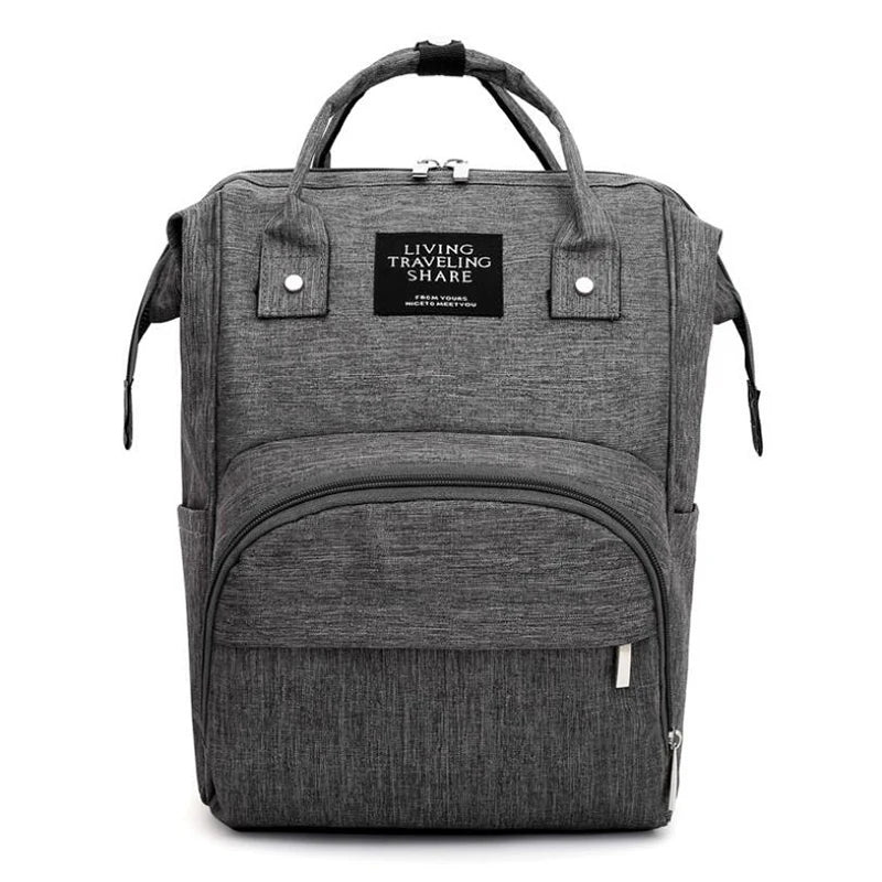 Unisex diaper backpack open, revealing organized compartments, large capacity for baby essentials, nappy bag.