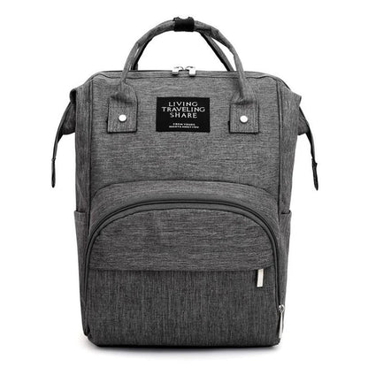 Unisex diaper backpack open, revealing organized compartments, large capacity for baby essentials, nappy bag.