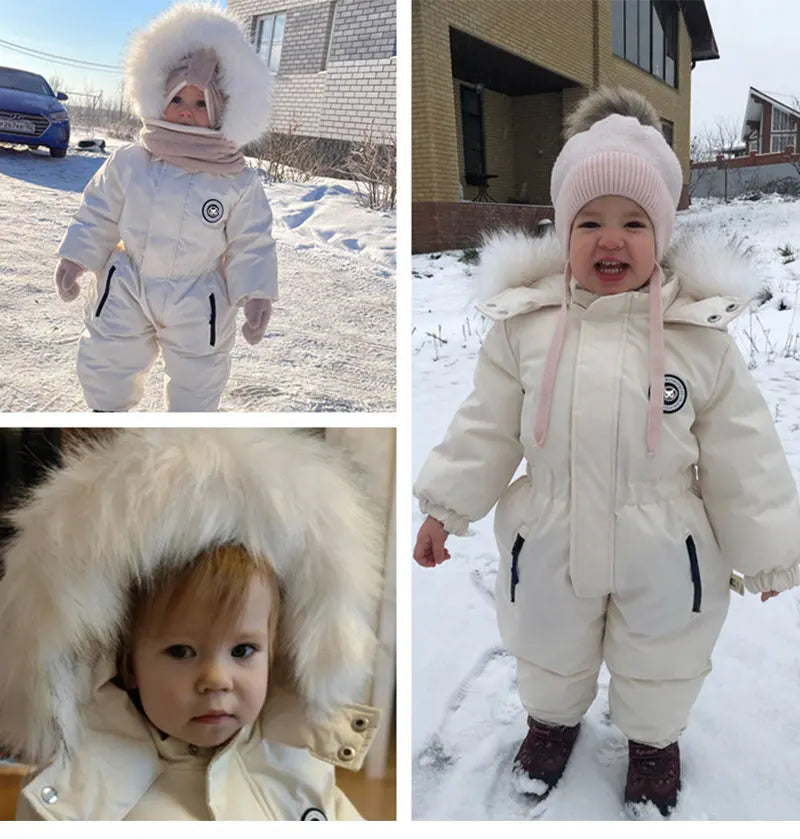 Baby wearing a warm unisex winter jumpsuit, cozy ski suit for toddlers outdoors